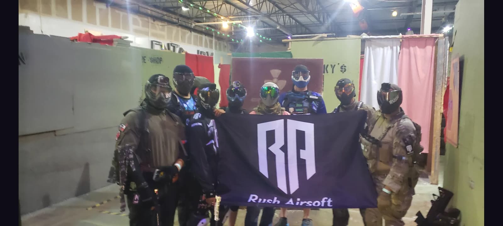 The crew together behind the banner at a game day